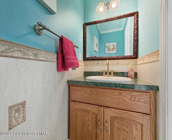 a bathroom with a granite countertop toilet sink and mirror