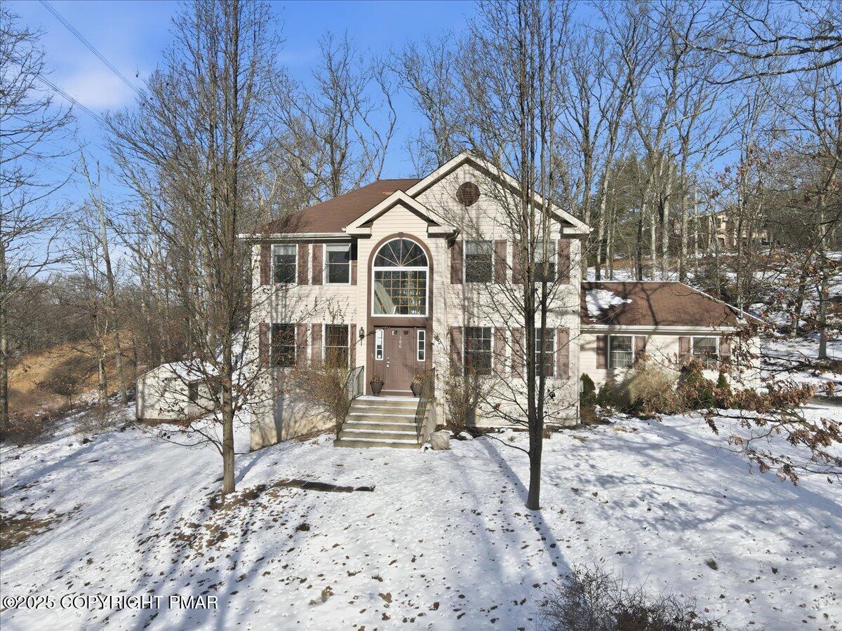 106 Ashley Court Bushkill, PA 18324 - Photo 2 of 61 a view of a large house with a yard covered with snow