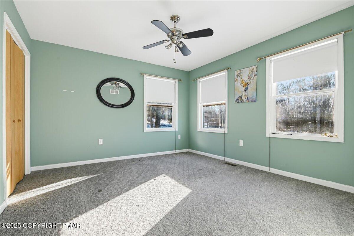 106 Ashley Court Bushkill, PA 18324 - Photo 23 of 61 a view of a livingroom with a window and a ceiling fan