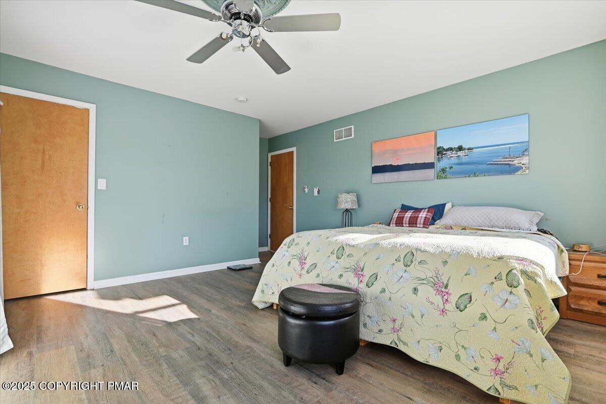 106 Ashley Court Bushkill, PA 18324 - Photo 31 of 61 a bedroom with a bed and wooden floor