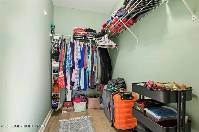 a view of a white house with a bench in front of it