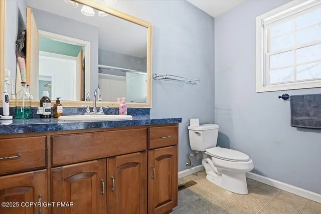 an aerial view of house with yard and mountain in the background