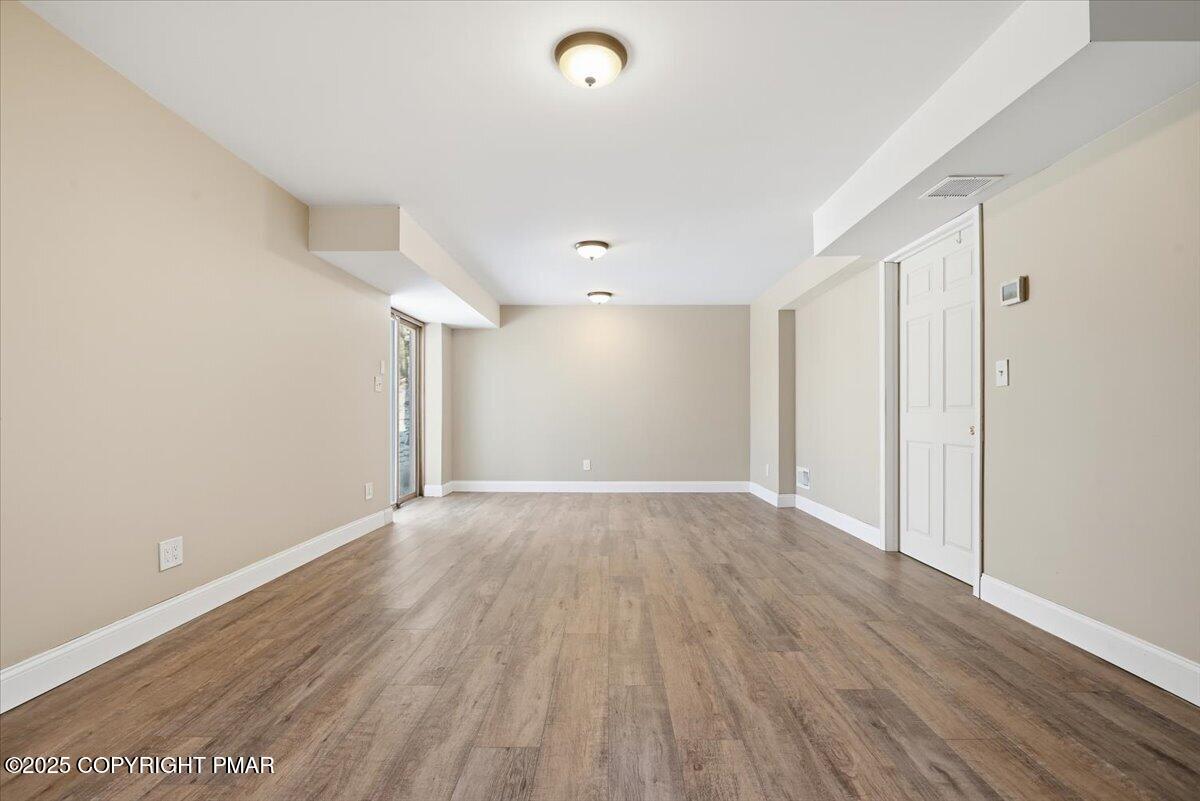 106 Ashley Court Bushkill, PA 18324 - Photo 37 of 61 a view of an empty room with wooden floor and a window