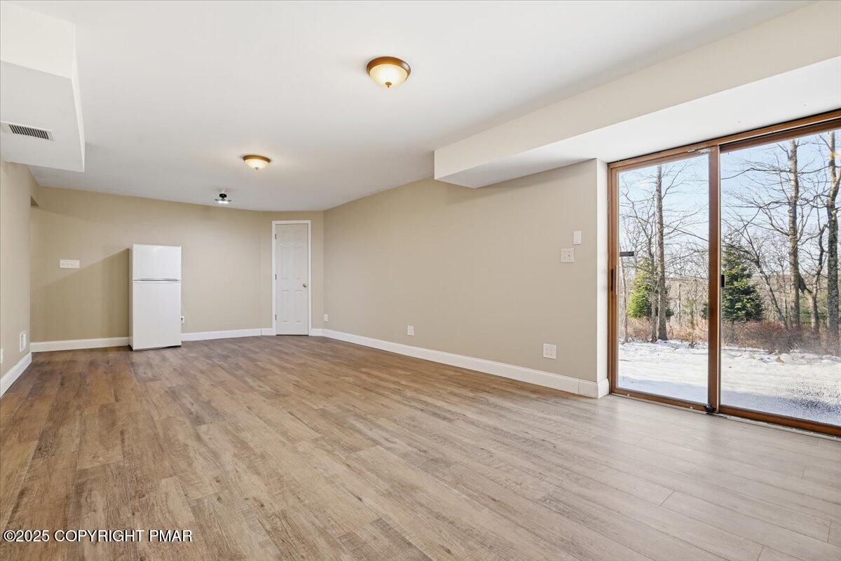 106 Ashley Court Bushkill, PA 18324 - Photo 38 of 61 wooden floor in an empty room with a window