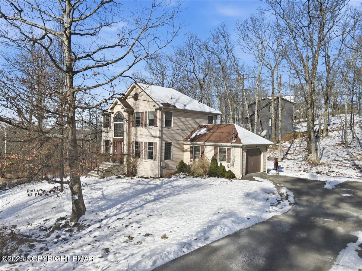 106 Ashley Court Bushkill, PA 18324 - Photo 50 of 61 a front view of a house with a yard covered in snow