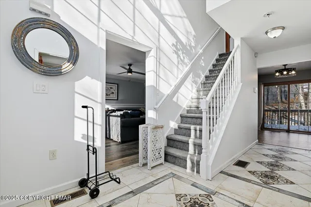 a view of an empty room with furniture and a window