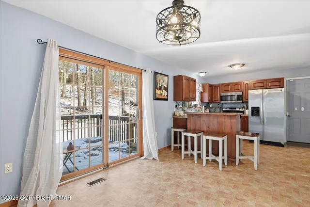 a view of a livingroom with a window and a ceiling fan