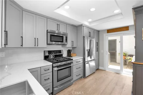 a kitchen with stainless steel appliances granite countertop a refrigerator stove and sink