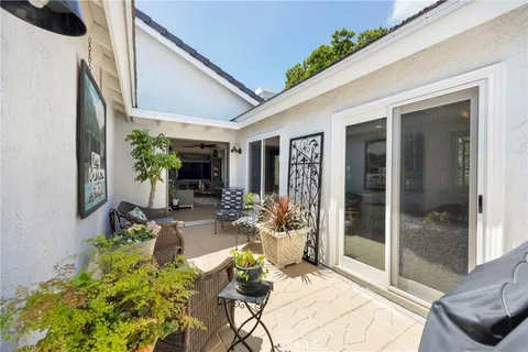 a front view of a house with outdoor seating