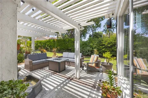 a view of a patio with table and chairs and potted plants
