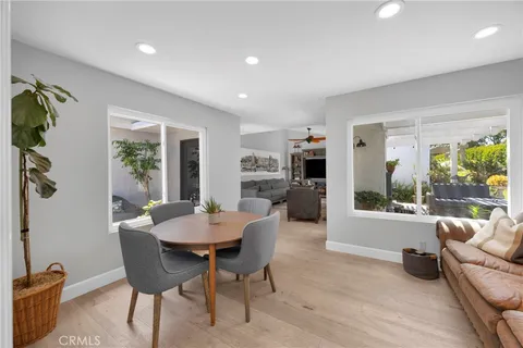 a view of a dining room with furniture and a potted plant