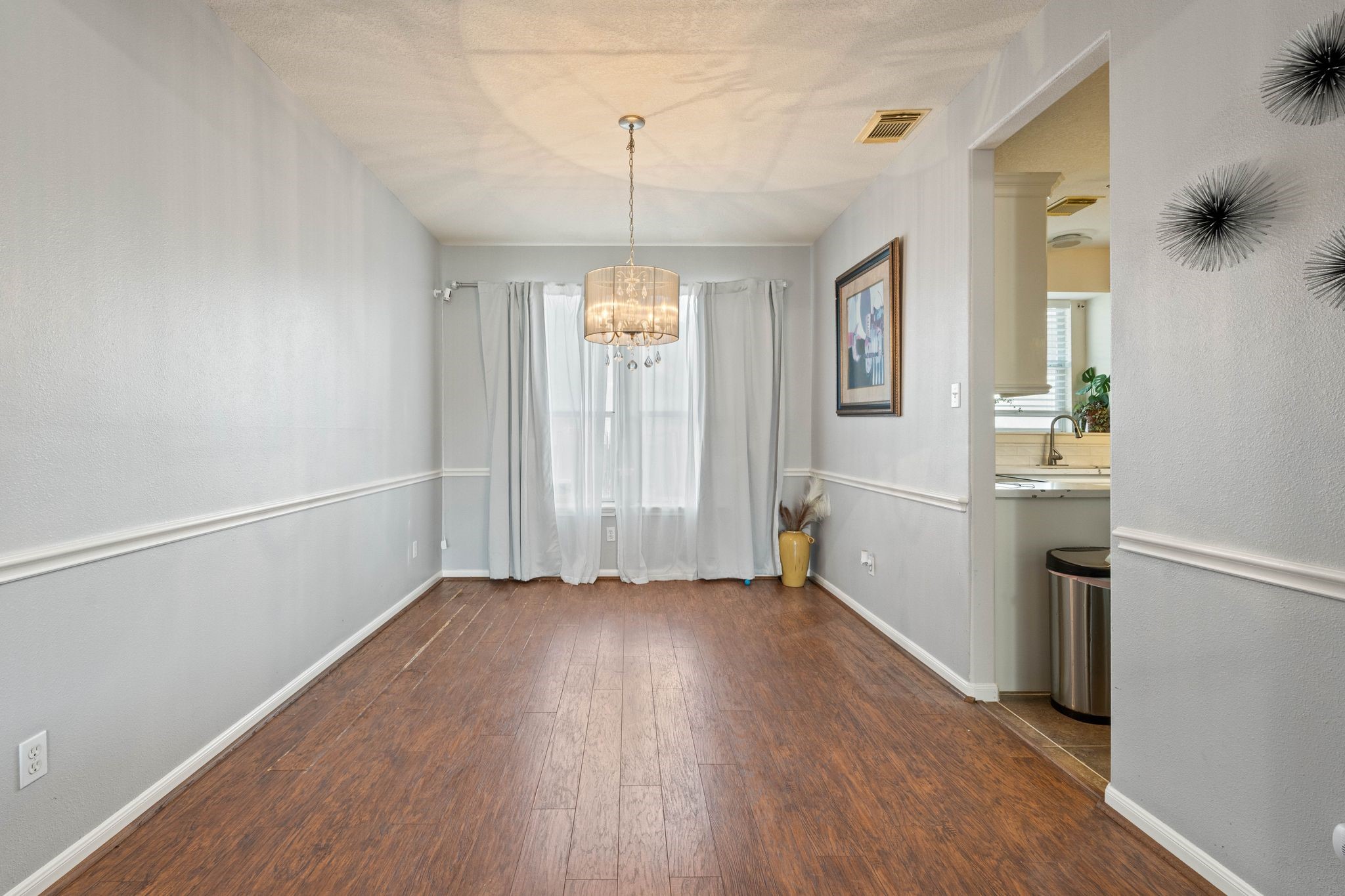 1908 Northampton Drive Conroe, TX 77303 - Photo 12 of 44 a view of an empty room with window and wooden floor
