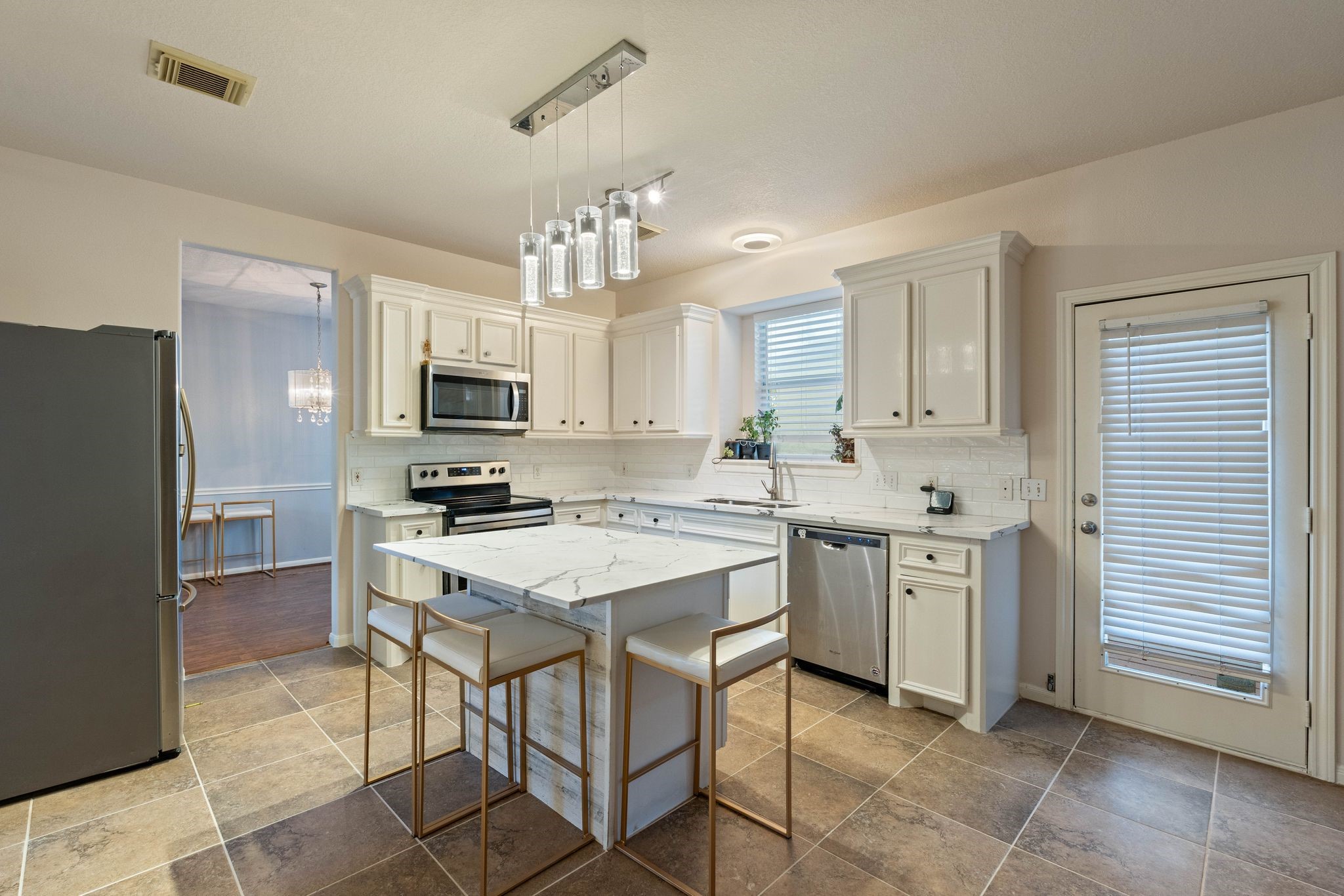 1908 Northampton Drive Conroe, TX 77303 - Photo 15 of 44 a kitchen with cabinets stainless steel appliances and a window