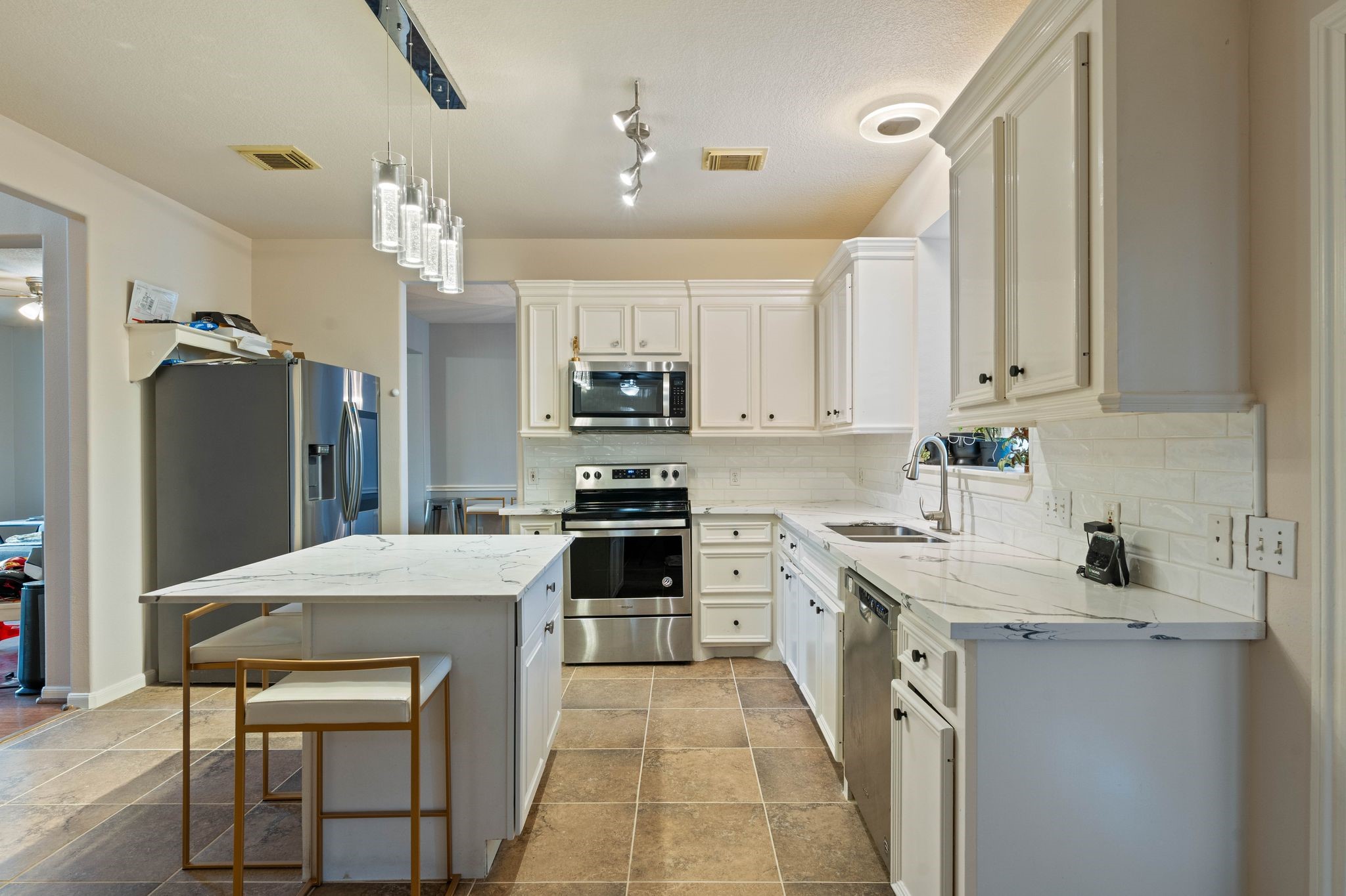 1908 Northampton Drive Conroe, TX 77303 - Photo 16 of 44 a kitchen with stainless steel appliances a stove refrigerator sink and microwave
