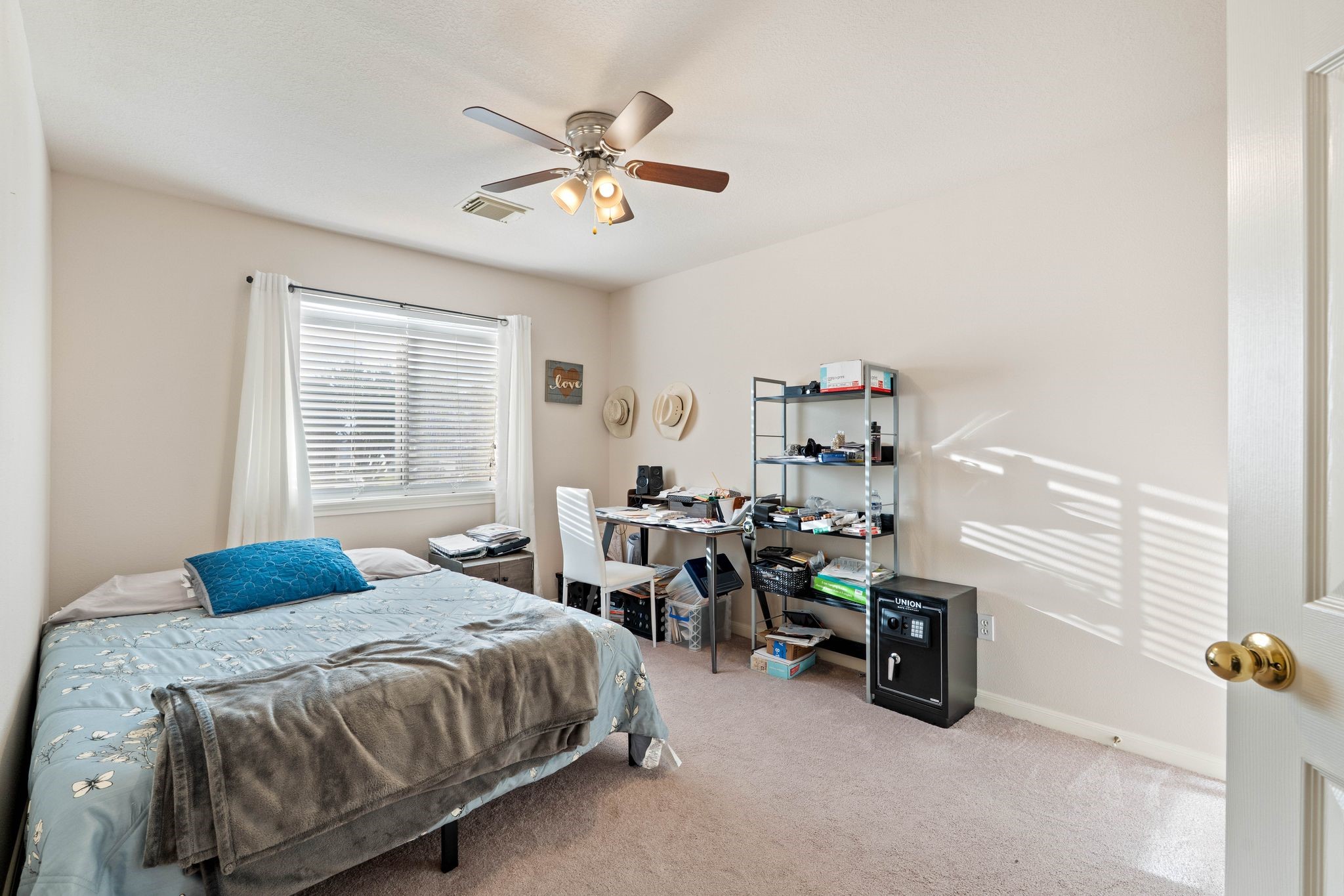 1908 Northampton Drive Conroe, TX 77303 - Photo 28 of 44 a bedroom with a bed and a chandelier