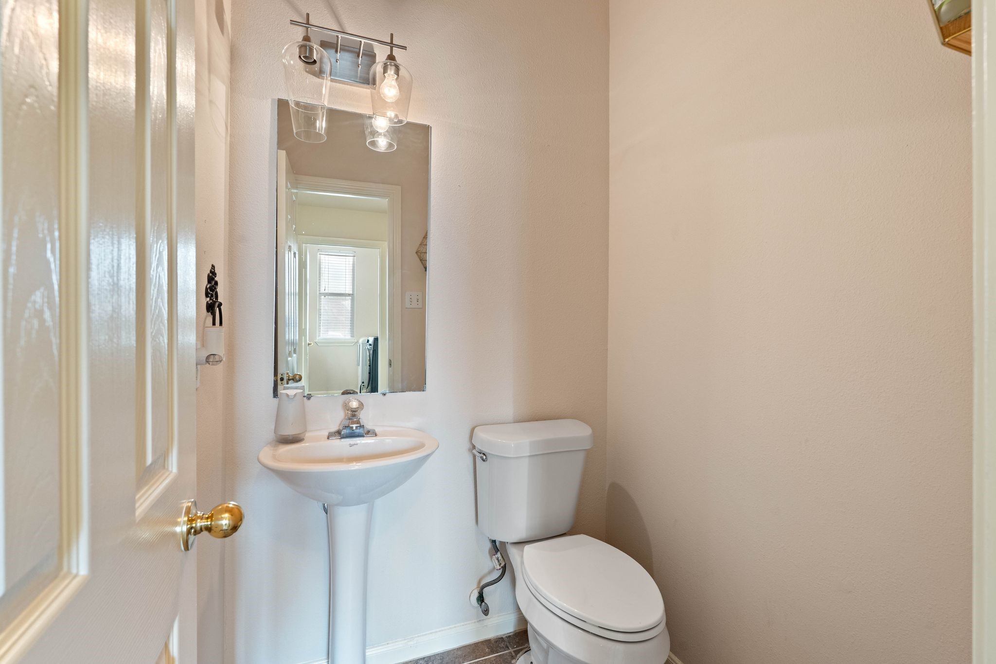 1908 Northampton Drive Conroe, TX 77303 - Photo 30 of 44 a bathroom with a toilet a sink and mirror