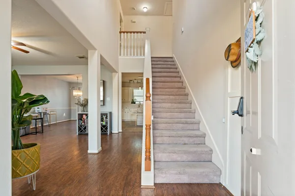 a view of entryway and hall with wooden floor