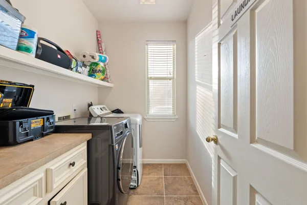 a view of a kitchen with fridge and wooden floor