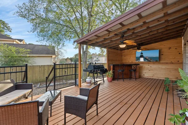 a view of a chairs and table on the wooden deck