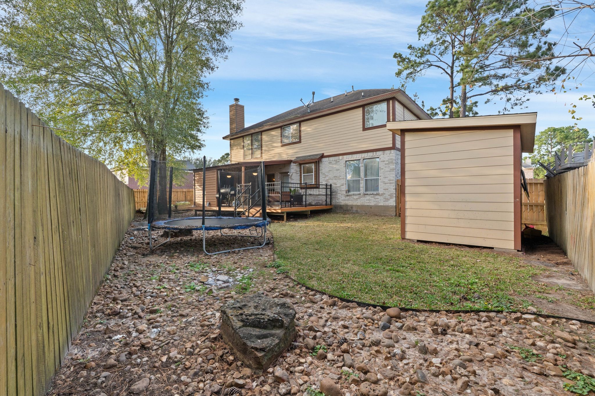 1908 Northampton Drive Conroe, TX 77303 - Photo 35 of 44 a backyard of a house with barbeque oven table and chairs