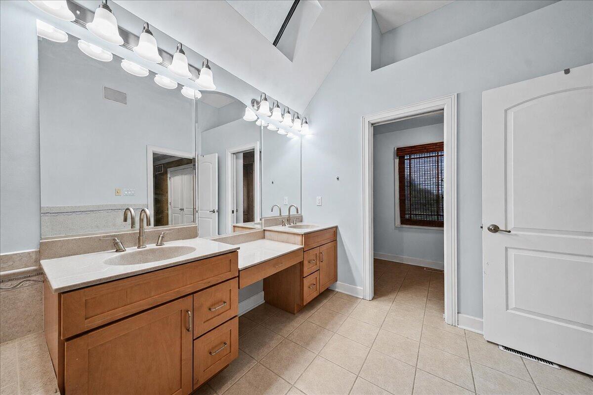 8751 Bridgewater Court Crown Point, IN 46307 - Photo 33 of 49 a spacious bathroom with a double vanity sink and a mirror