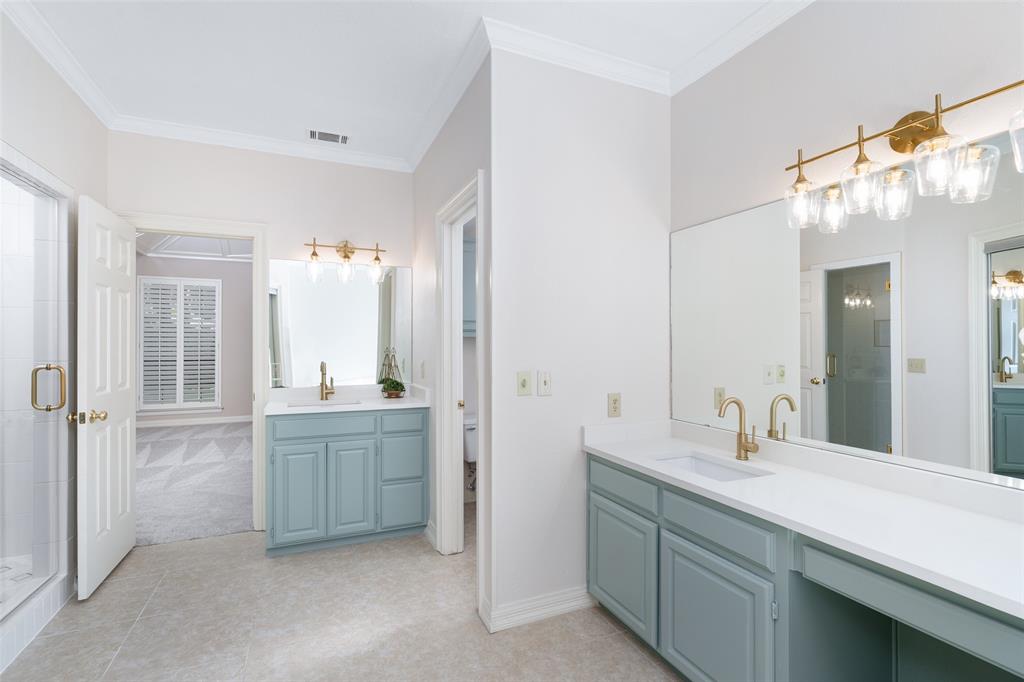 7016 Harvey Lane Plano, TX 75025 - Photo 15 of 26 a bathroom with double vanity sinks and a mirror