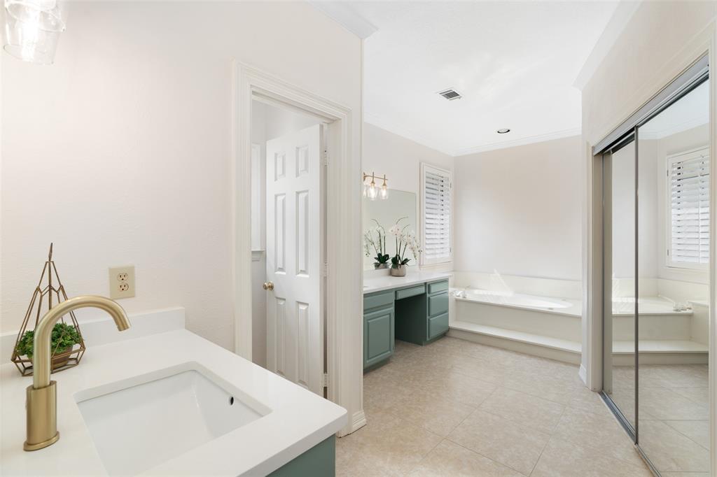 7016 Harvey Lane Plano, TX 75025 - Photo 16 of 26 a bathroom with a bathtub and a sink