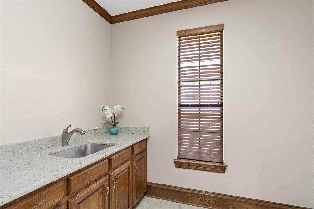 7016 Harvey Lane Plano, TX 75025 - Photo 21 of 26 a bathroom with a sink and a mirror