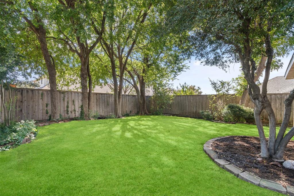 7016 Harvey Lane Plano, TX 75025 - Photo 23 of 26 a view of a backyard with large trees