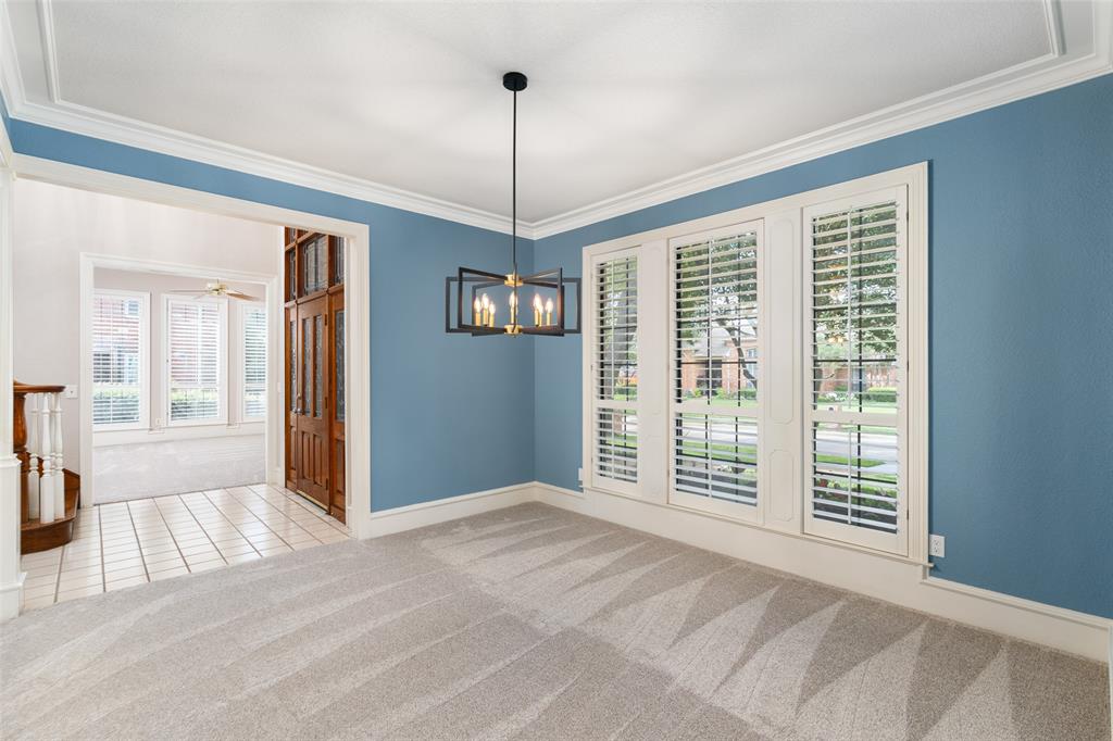 7016 Harvey Lane Plano, TX 75025 - Photo 6 of 26 a view of an empty room with window and chandelier