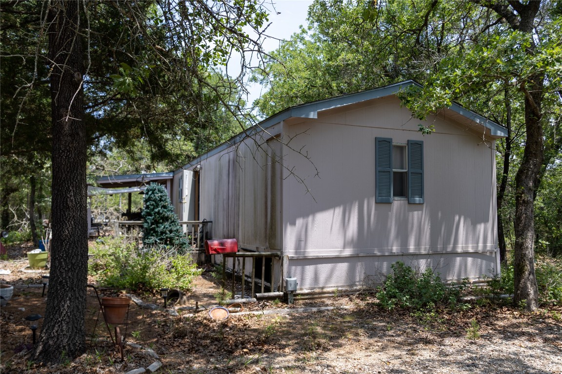 642 Hidden Oaks Drive Elgin, TX 78621 - Photo 11 of 36 a view of backyard of house with wooden fence and a large tree