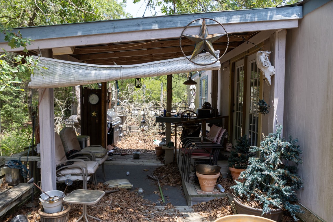 642 Hidden Oaks Drive Elgin, TX 78621 - Photo 20 of 36 a view of a porch with chairs and potted plants