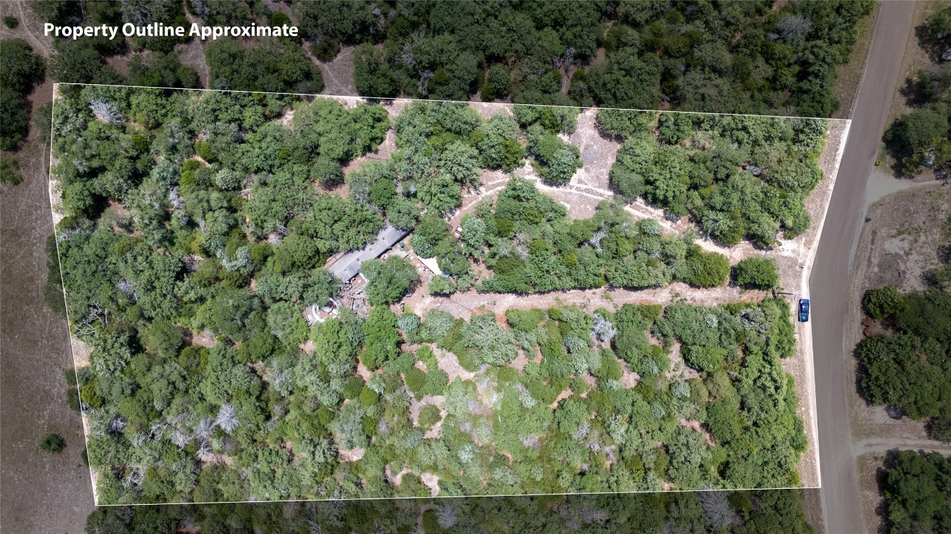 642 Hidden Oaks Drive Elgin, TX 78621 - Photo 2 of 36 an aerial view of residential house with outdoor space and trees all around