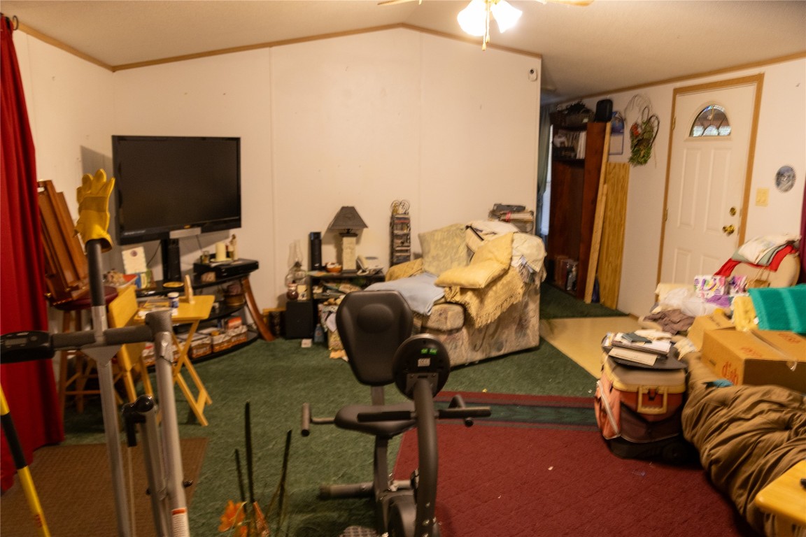 642 Hidden Oaks Drive Elgin, TX 78621 - Photo 28 of 36 a living room with furniture and a flat screen tv