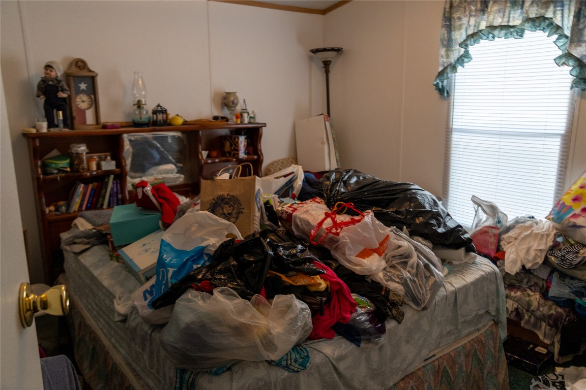 642 Hidden Oaks Drive Elgin, TX 78621 - Photo 32 of 36 a bed room with a bed and a car