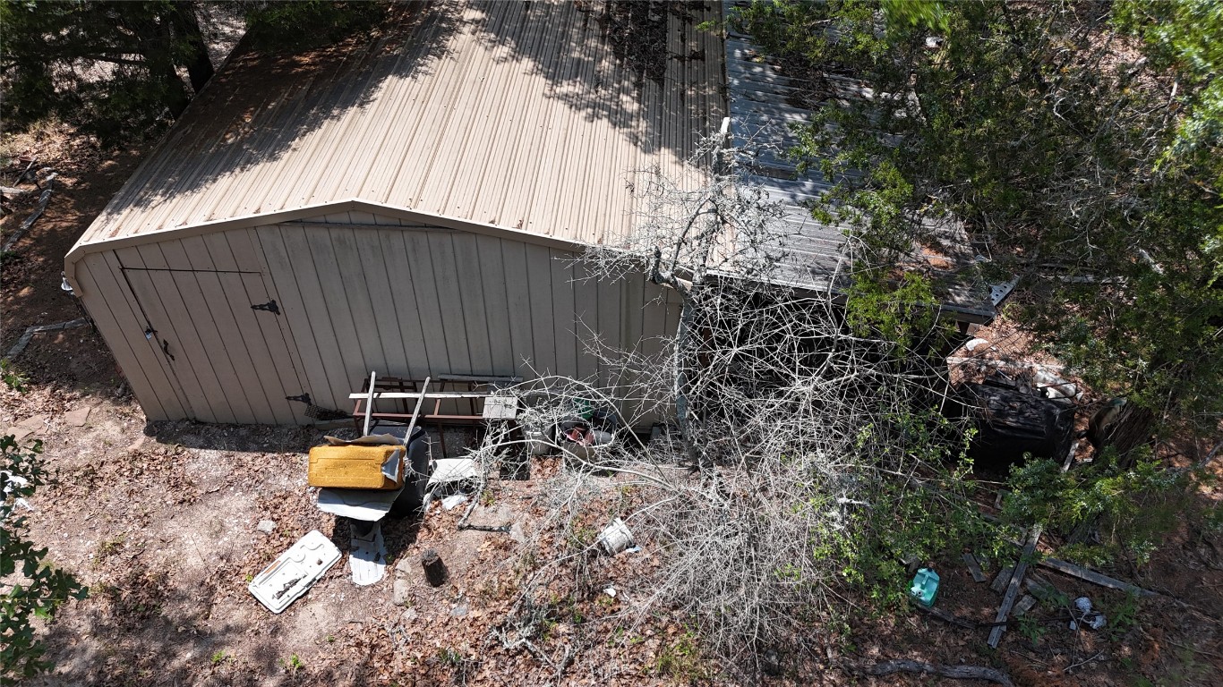 642 Hidden Oaks Drive Elgin, TX 78621 - Photo 4 of 36 a backyard of a house with table and chairs under an umbrella