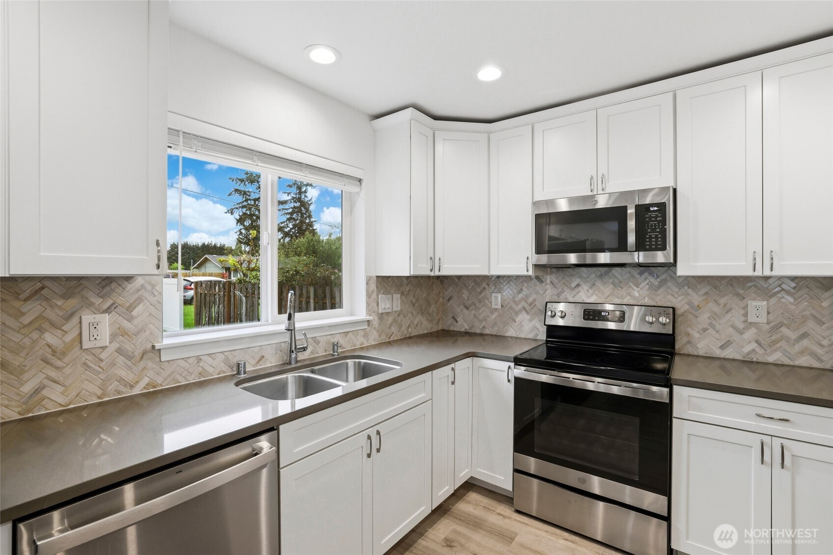 9815 178th Way Southwest Rochester, WA 98579 - Photo 15 of 36 a kitchen with stainless steel appliances a sink stove and microwave