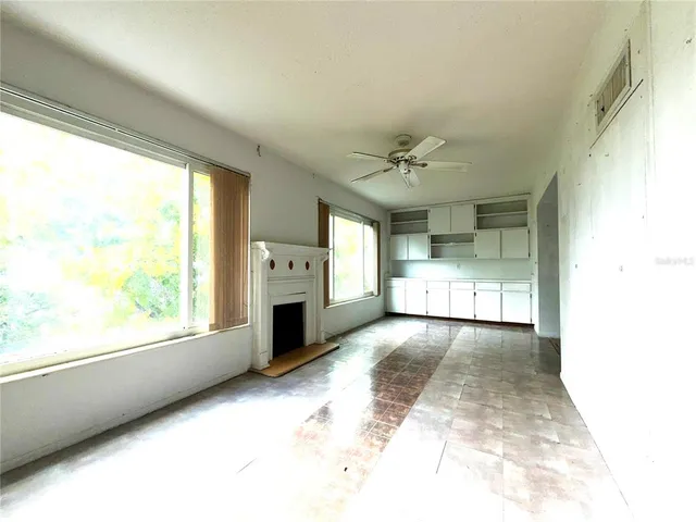 a view of a kitchen with a sink and a fireplace
