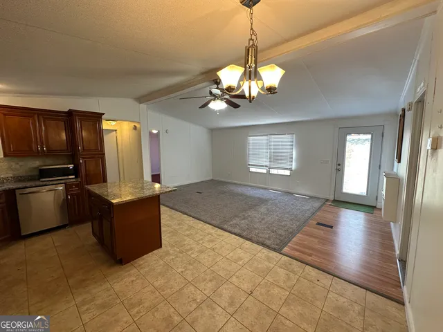 a view of a kitchen with a sink and refrigerator