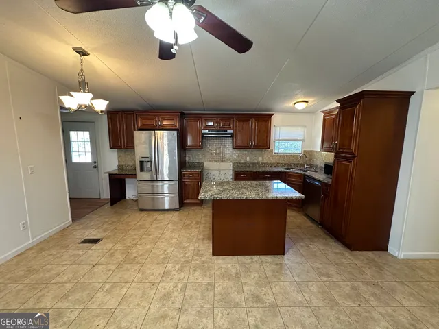 a kitchen with a refrigerator sink and stove