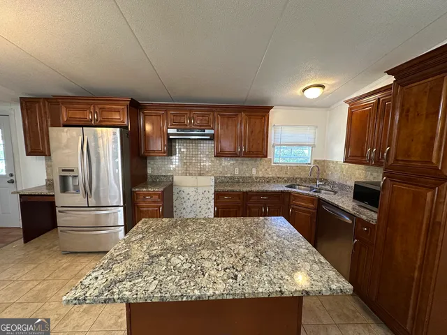 a kitchen with a stove sink and cabinets