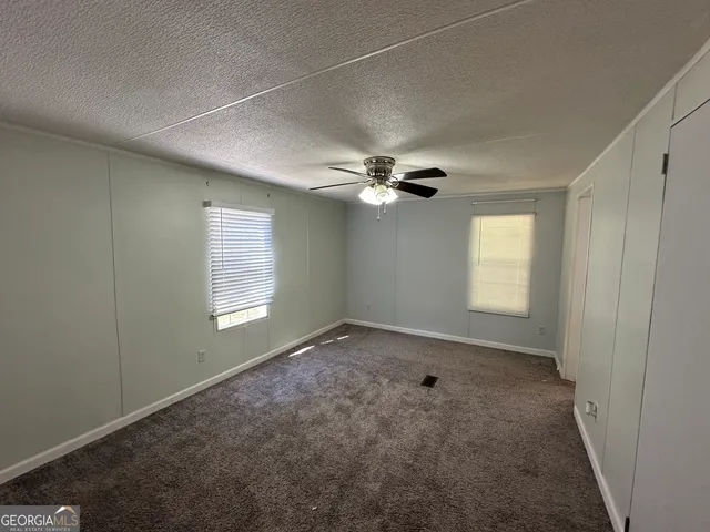 a bathroom with a granite countertop tub sink and mirror