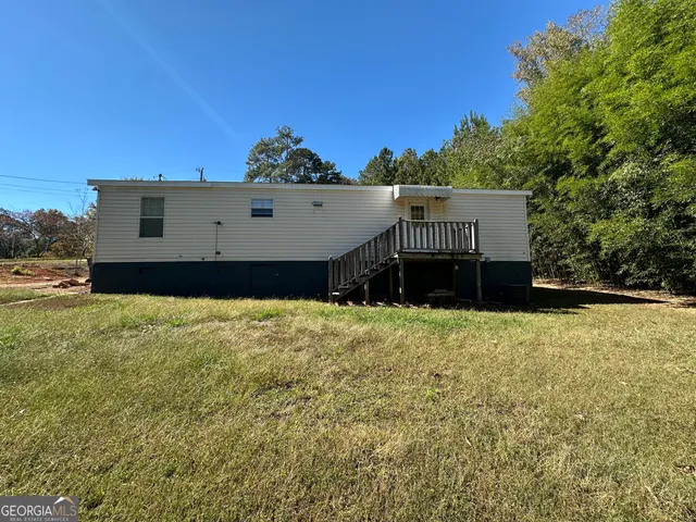 a view of a big house with a yard