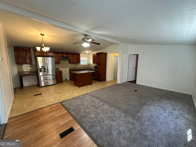a view of a kitchen with a sink and cabinets