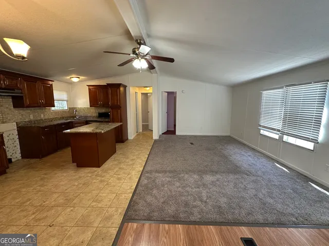 a view of a kitchen with a stove cabinets and stainless steel appliances