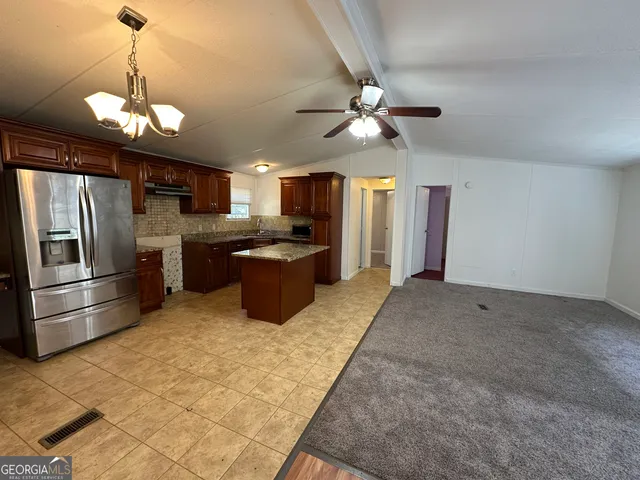 a living room with kitchen island furniture and a chandelier