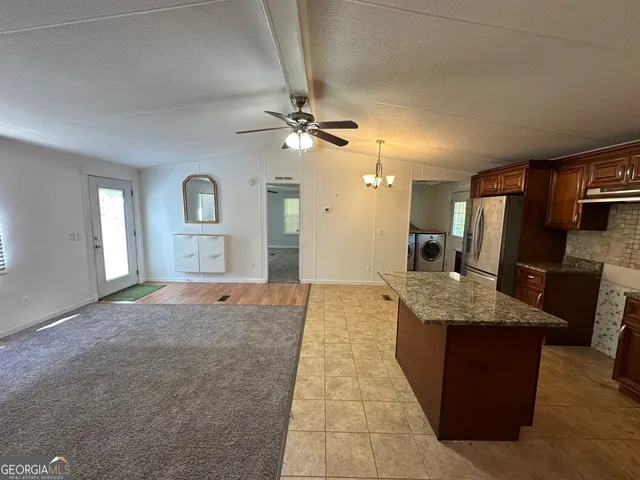 a view of kitchen with sink microwave and refrigerator
