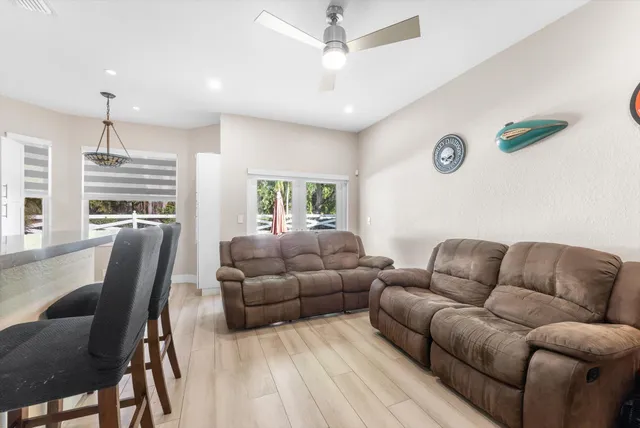 a bed room with a bed and a ceiling fan