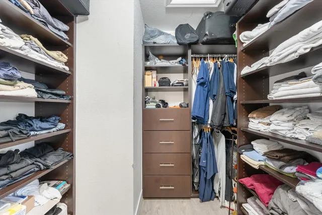 a bathroom with a glass shower door and a sink