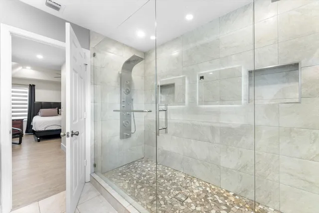 a bedroom with a bed and a chandelier